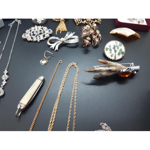 14 - A collection of vintage costume jewellery to include a hallmarked 925 silver cross with inset faux d... 