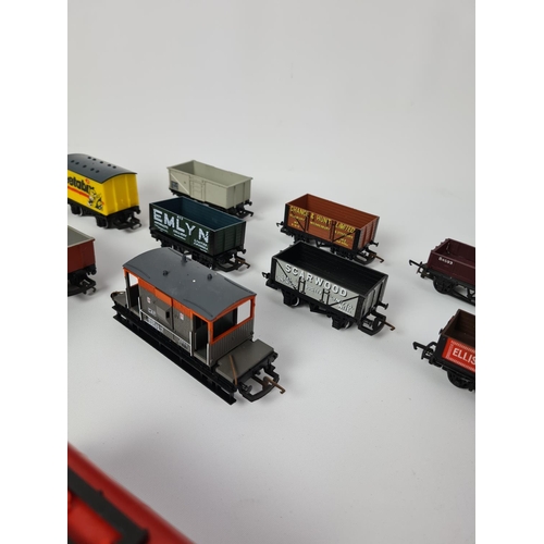 143 - A box containing fifteen various OO gauge wagons to include Hornby Weetabix, Hornby Texaco, Hornby E... 