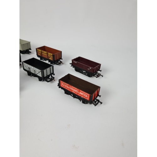 143 - A box containing fifteen various OO gauge wagons to include Hornby Weetabix, Hornby Texaco, Hornby E... 