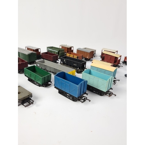 145 - A box containing twenty three OO gauge wagons to include Hornby Tarmac Quarry Products etc.