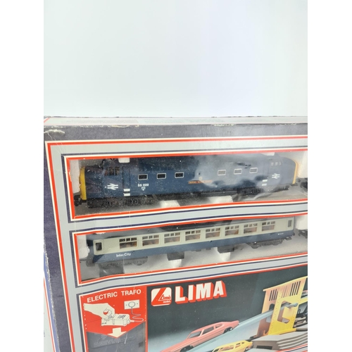 149 - A boxed vintage Lima OO gauge train and action accessory set