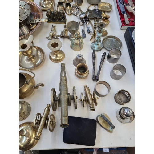 201 - A large collection of various metalware to include brass candlesticks, pair of brass eagle figurines... 