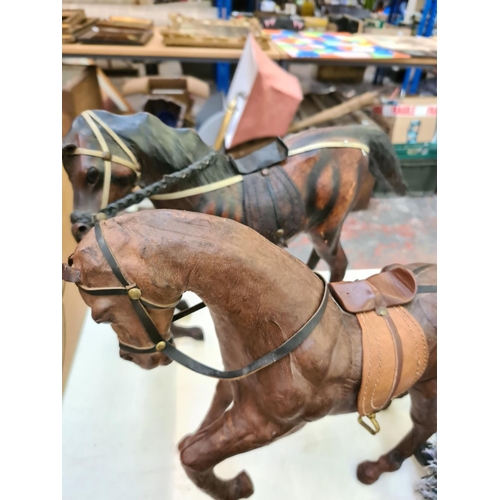 259 - A collection of various items to include a vintage leather bridge set, two leather horse figurines, ... 