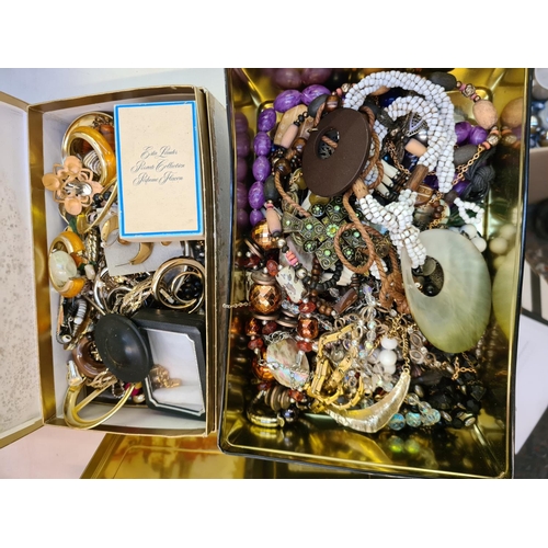 260 - Two boxes containing assorted costume jewellery