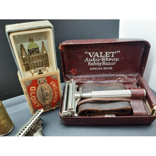 48 - A tin containing various collectables to include vintage Valet safety razor, bracelets etc.