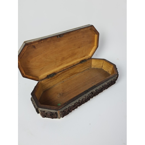 97 - A vintage Anglo Indian heavily carved glove box with hunting scene design - approx. 30cm long