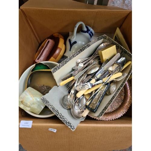 1283 - Two boxes containing glassware, brass plate, cutlery, table mats, Sadler blue and white bowl etc.