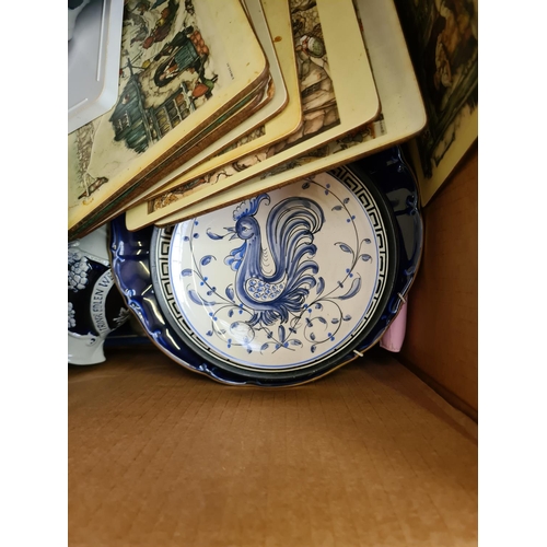 1283 - Two boxes containing glassware, brass plate, cutlery, table mats, Sadler blue and white bowl etc.