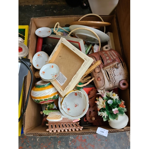 1284 - Three boxes containing red glass fruit bowl, carved wooden deer, stainless steel tea and coffee set,... 