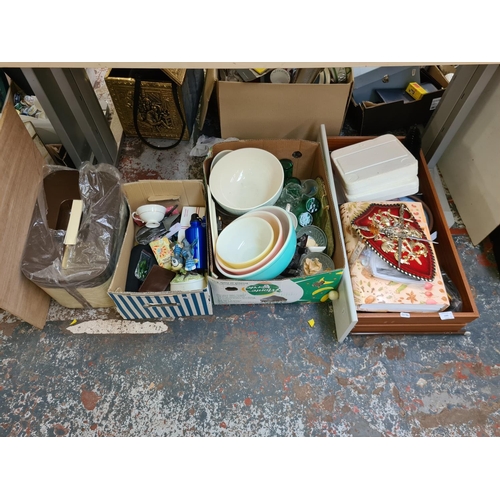 1305 - Three boxes containing set of three coloured Pyrex mixing bowls, 1970s plastic picnic set, carved wo... 