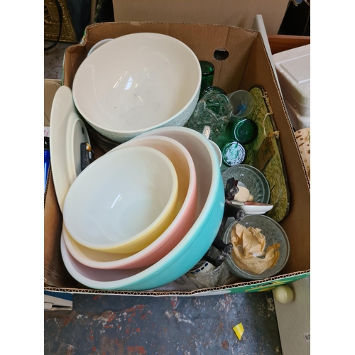 1305 - Three boxes containing set of three coloured Pyrex mixing bowls, 1970s plastic picnic set, carved wo... 