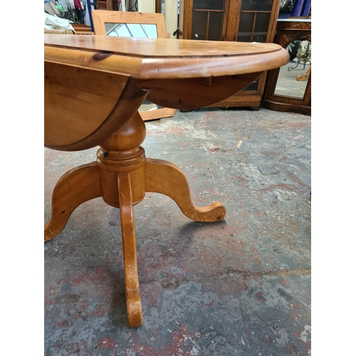 304 - A modern pine drop leaf pedestal dining table - approx. 105cm wide x 78cm high