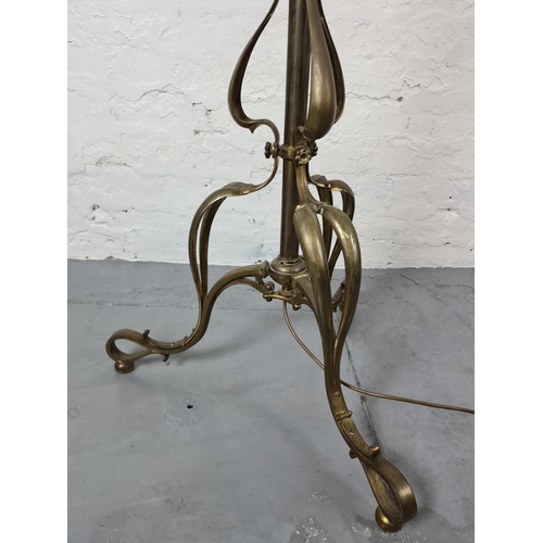 305 - An Art Nouveau brass standard lamp - approx. 163cm with shade