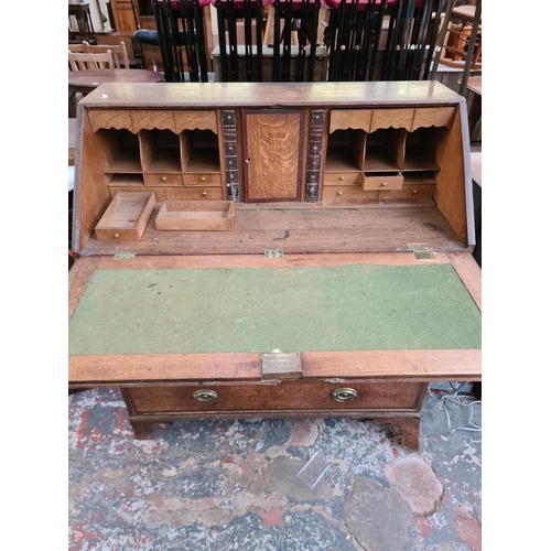 308 - A George III oak bureau - approx. 106cm wide x 54cm deep x 117cm high