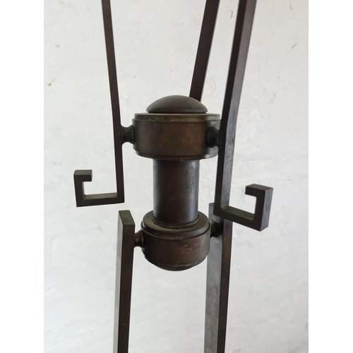 310 - A Charles Rennie Mackintosh style patinated bronze standard lamp