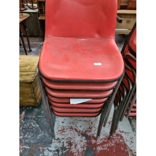 313 - Thirty five 1970s 'Sit' red vinyl stacking chairs by Frederick Restall Production design group