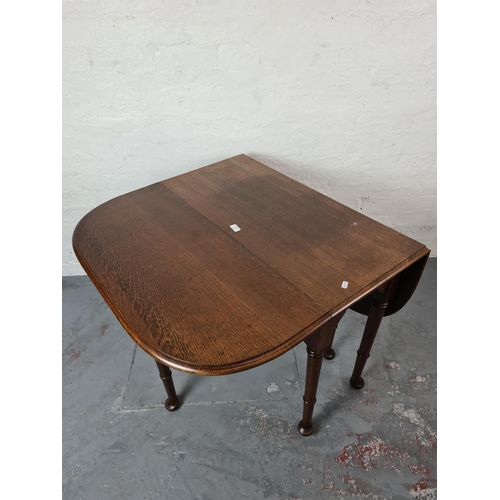 325 - An early 20th century oak drop leaf gate leg dining table - approx. 90cm wide x 121cm long x 75cm hi... 