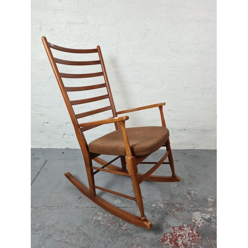 335 - A mid 20th century teak ladder back rocking chair