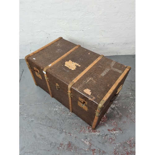 340 - A vintage brown canvas and wooden banded travel trunk