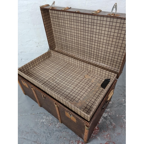 340 - A vintage brown canvas and wooden banded travel trunk