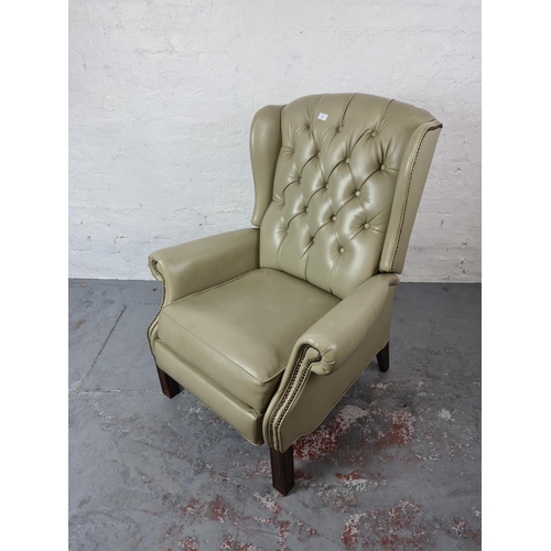 345 - A vintage mint green leatherette Chesterfield wing back reclining arm chair