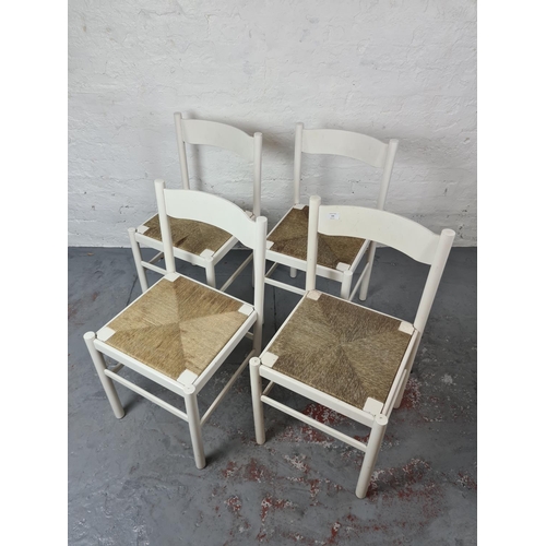 346 - A set of four mid 20th century white painted dining chairs with rush seats