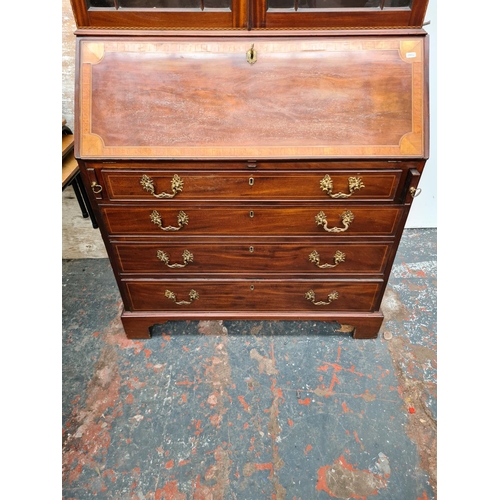 402 - A fine 19th century inlaid mahogany bureau bookcase, the figured fall front with broad satinwood ban... 