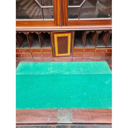 402 - A fine 19th century inlaid mahogany bureau bookcase, the figured fall front with broad satinwood ban... 