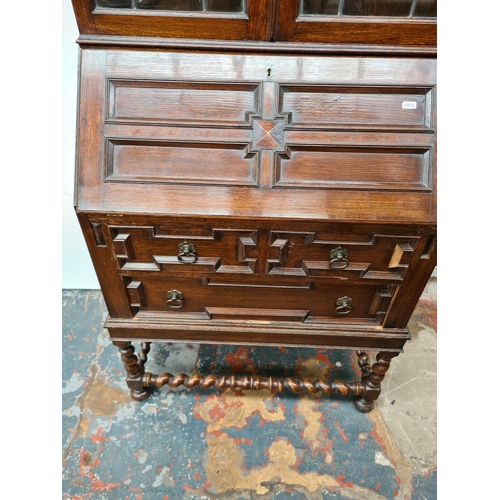 403 - An early 20th century Jacobean style oak bureau bookcase