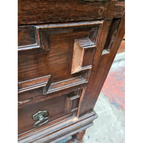 403 - An early 20th century Jacobean style oak bureau bookcase