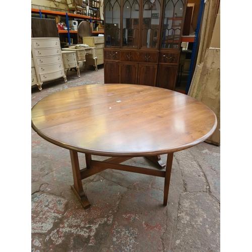 410 - An Ercol elm drop leaf dining table