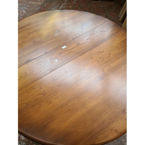 410 - An Ercol elm drop leaf dining table