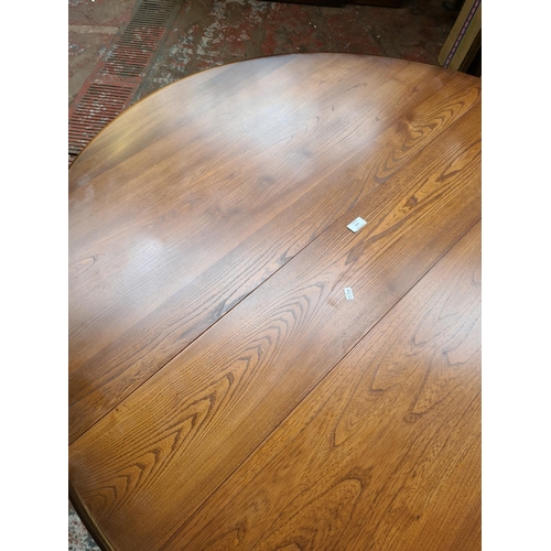 410 - An Ercol elm drop leaf dining table