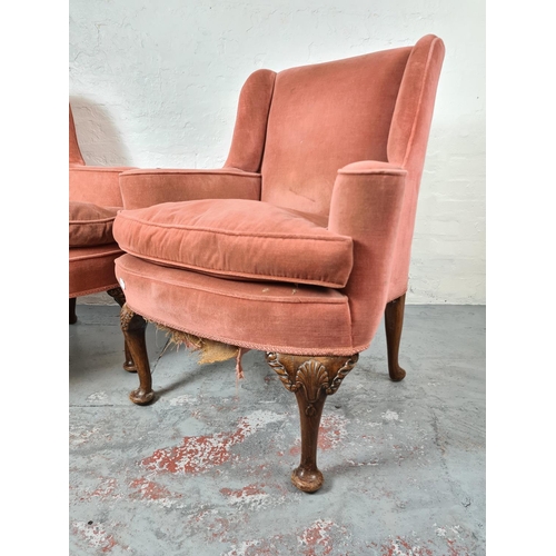 411 - A pair of Georgian pink upholstered arm chairs on carved oak cabriole supports with shell design