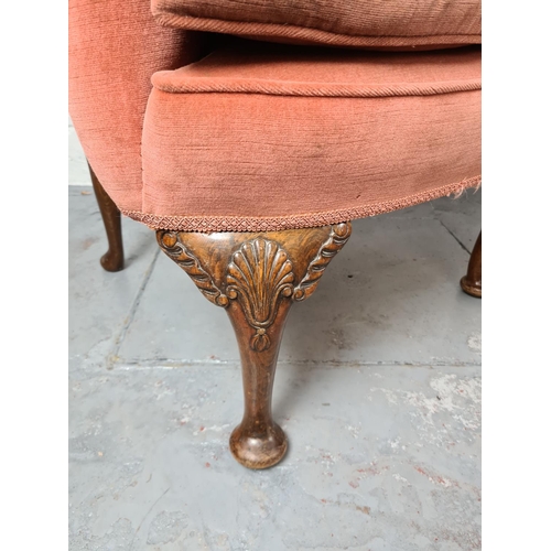 411 - A pair of Georgian pink upholstered arm chairs on carved oak cabriole supports with shell design