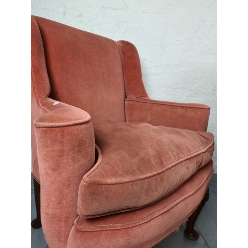 411 - A pair of Georgian pink upholstered arm chairs on carved oak cabriole supports with shell design