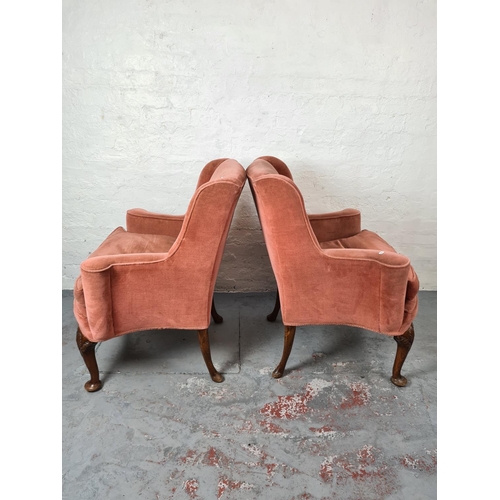 411 - A pair of Georgian pink upholstered arm chairs on carved oak cabriole supports with shell design