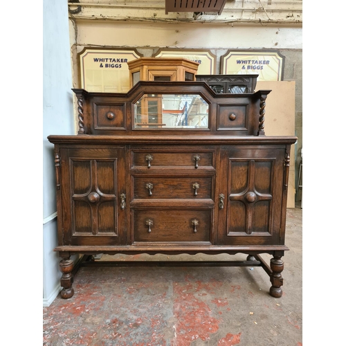 423 - An early 20th century oak mirrored back sideboard - approx. 137cm wide x 137cm high x 56cm deep