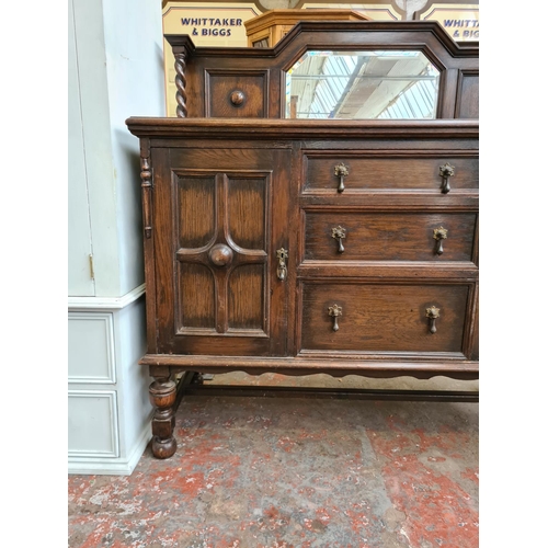 423 - An early 20th century oak mirrored back sideboard - approx. 137cm wide x 137cm high x 56cm deep