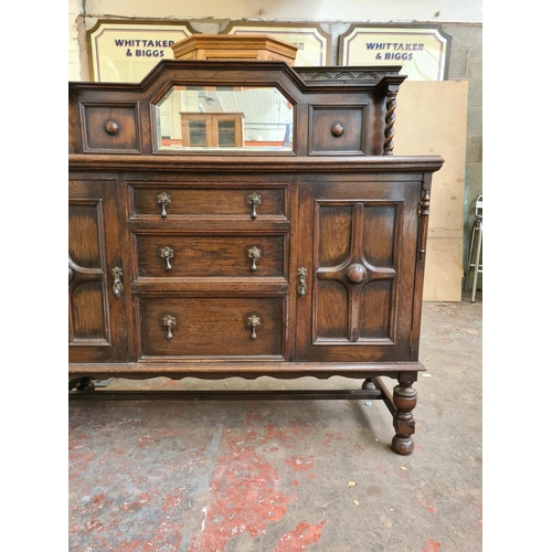 423 - An early 20th century oak mirrored back sideboard - approx. 137cm wide x 137cm high x 56cm deep