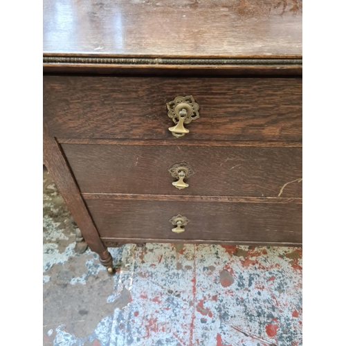 429 - An early 20th century oak dressing chest on casters with mirror on barley twist supports - approx. 1... 