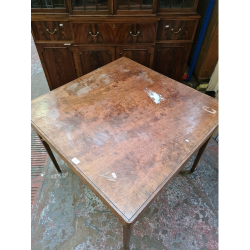 435 - An early 20th century walnut folding games table