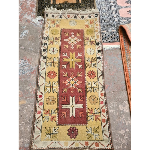 445 - Five various vintage rugs to include a 1970's woolen rug, a large hall runner, a silk machine woven ... 