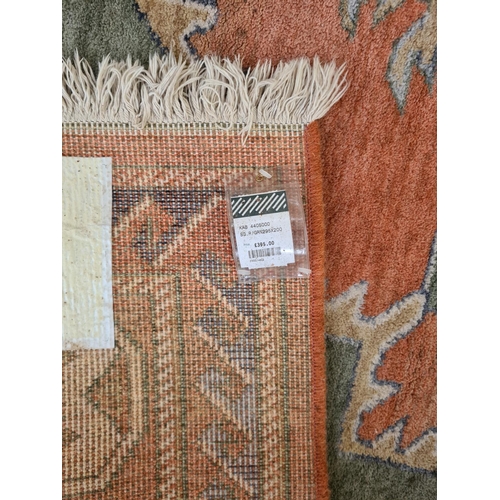 449 - A large vintage style rug with orange, green and blue tones