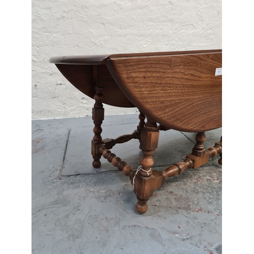 377 - An Ercol elm drop leaf occasional table