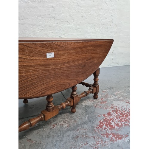 377 - An Ercol elm drop leaf occasional table