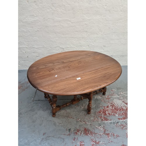 377 - An Ercol elm drop leaf occasional table