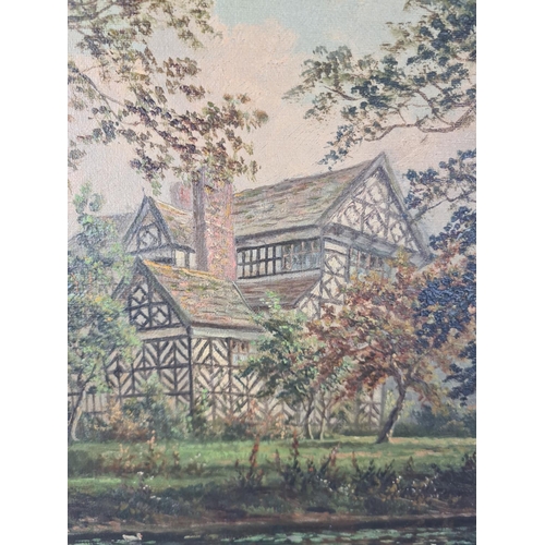 267 - An early 20th century gilt framed oil on canvas of Little Moreton Hall with gentleman to foreground ... 