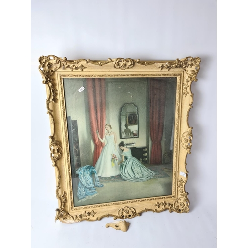 279 - A large gilt framed print depicting bride and bridesmaid getting ready approx. 76cm x 67cm