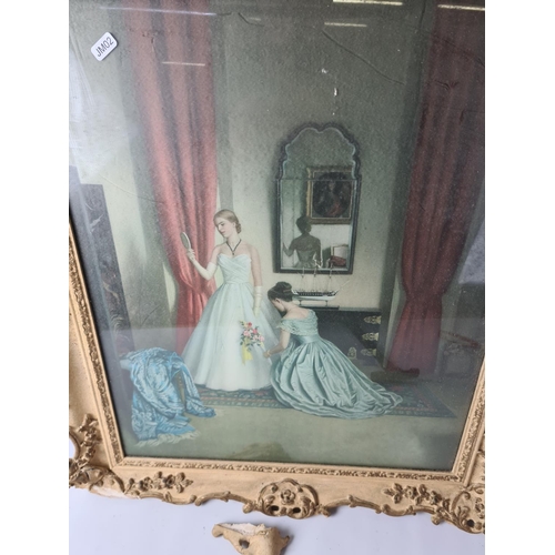 279 - A large gilt framed print depicting bride and bridesmaid getting ready approx. 76cm x 67cm